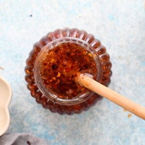 one glass jar of hot honey along with one wooden stick.