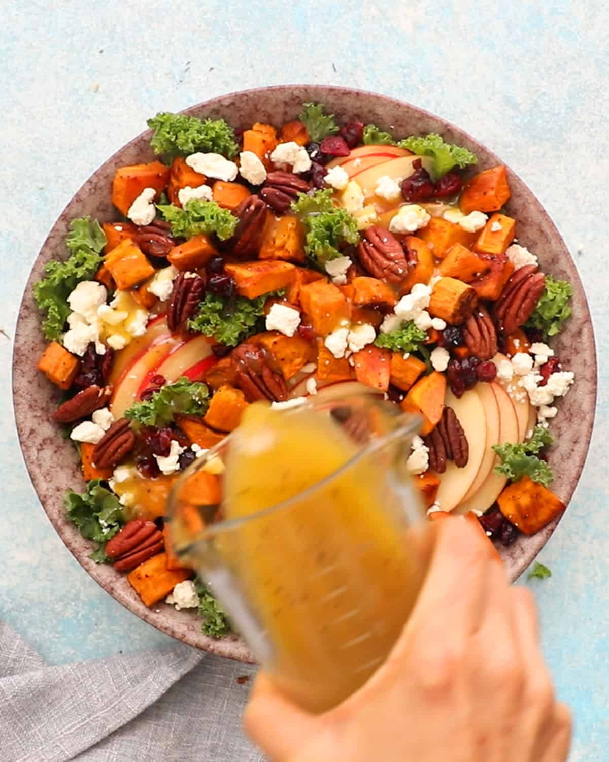 sweet potato kale salad in a large brown bowl.