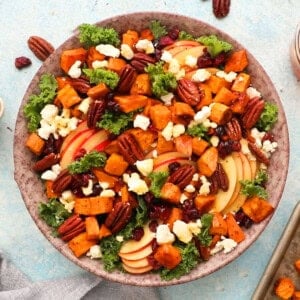 sweet potato kale salad in a brown bowl.