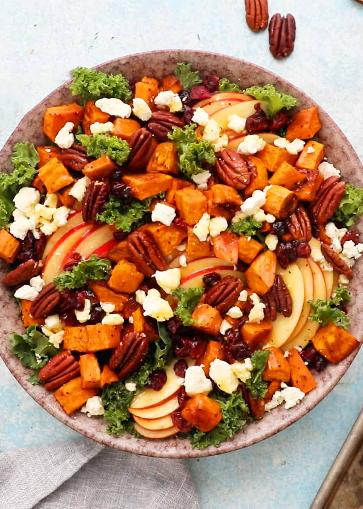 sweet potato kale salad in a large brown bowl.