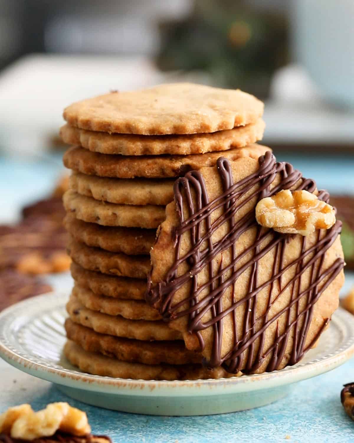 a stalk walnut cookies in a green plate.