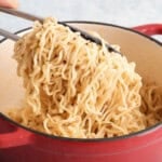 white garlic ramen noodles in a red pot.