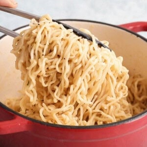 white garlic ramen noodles in a red pot.
