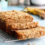 one brown loaf of eggless banana bread on a wire rack.
