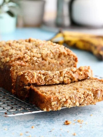 one brown loaf of eggless banana bread on a wire rack.