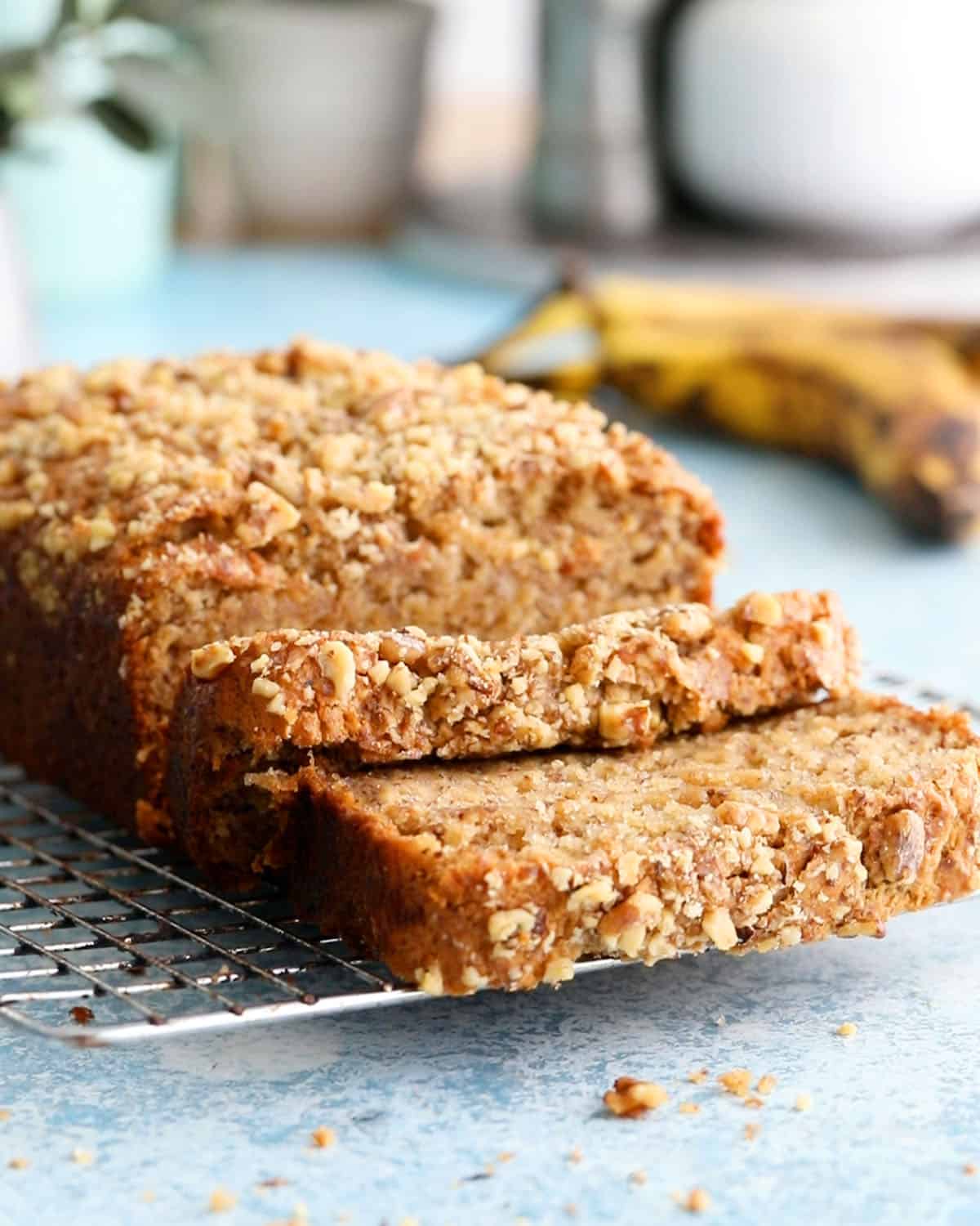 Golden brown homemade eggless banana bread loaf cooling on a wire rack