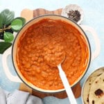 Orange colored Indian Butter Chickpeas in a white pan.