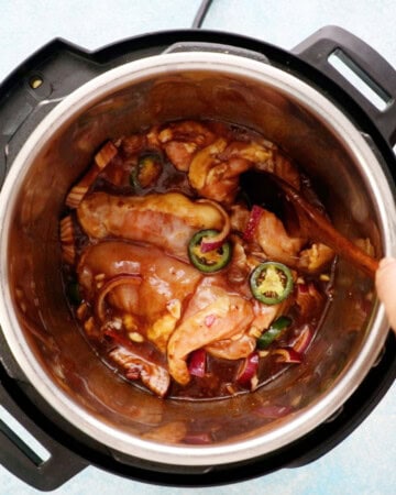 pink chicken, onions, green jalapeno in an instant pot.