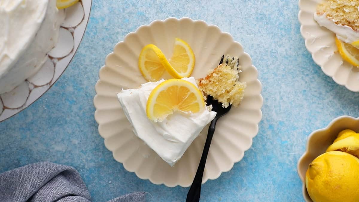 one slice of lemon cake in a white fluted plate.