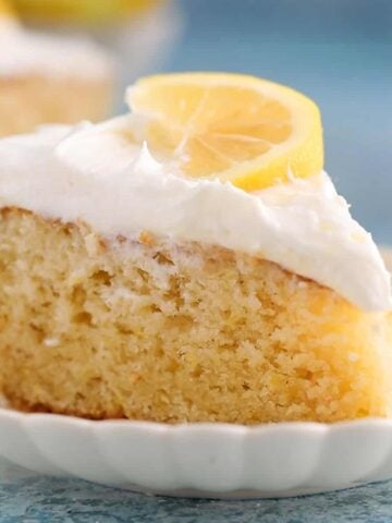 one slice of lemon cake in a white fluted plate.