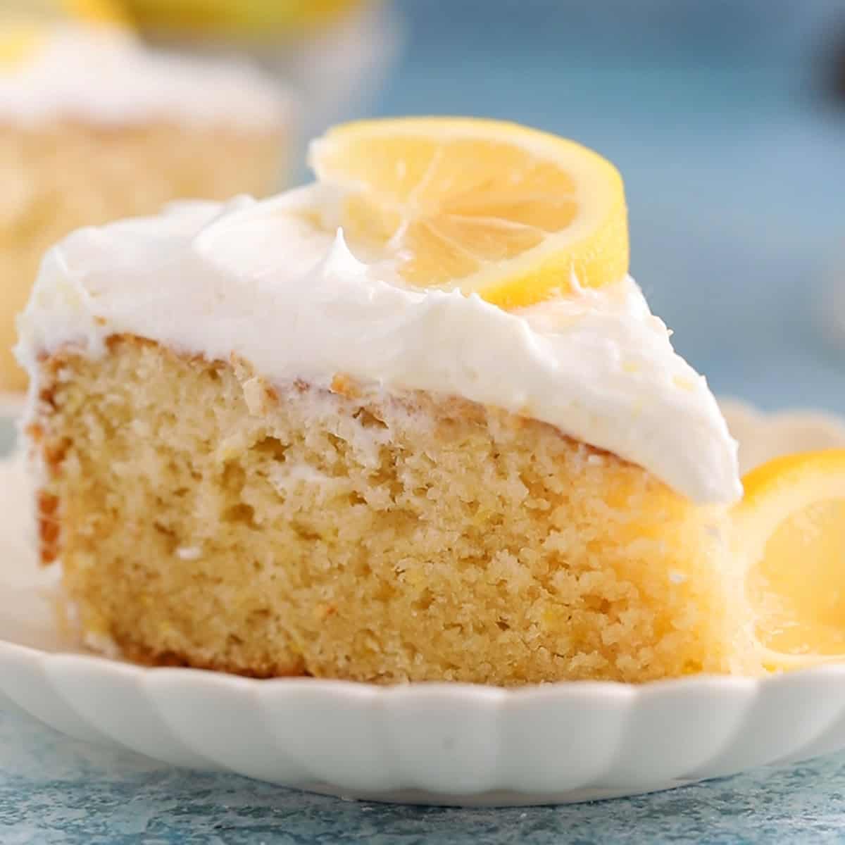one slice of lemon cake in a white fluted plate.