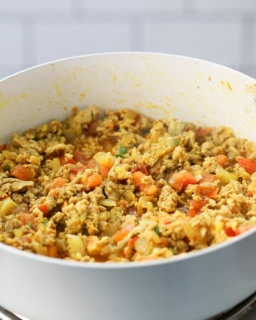 ground chicken keema cooking in a white skillet.