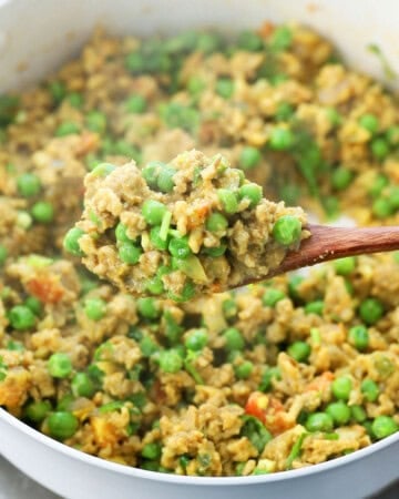 cooked chicken keema with green peas in a white skillet. 