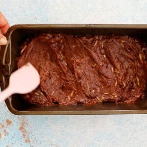 brown zucchini bread batter in a metal loaf pan.