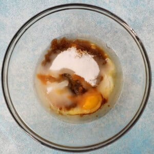 white sugar and eggs in a glass bowl.