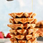 6 cottage cheese waffles stacked on a grey plate.