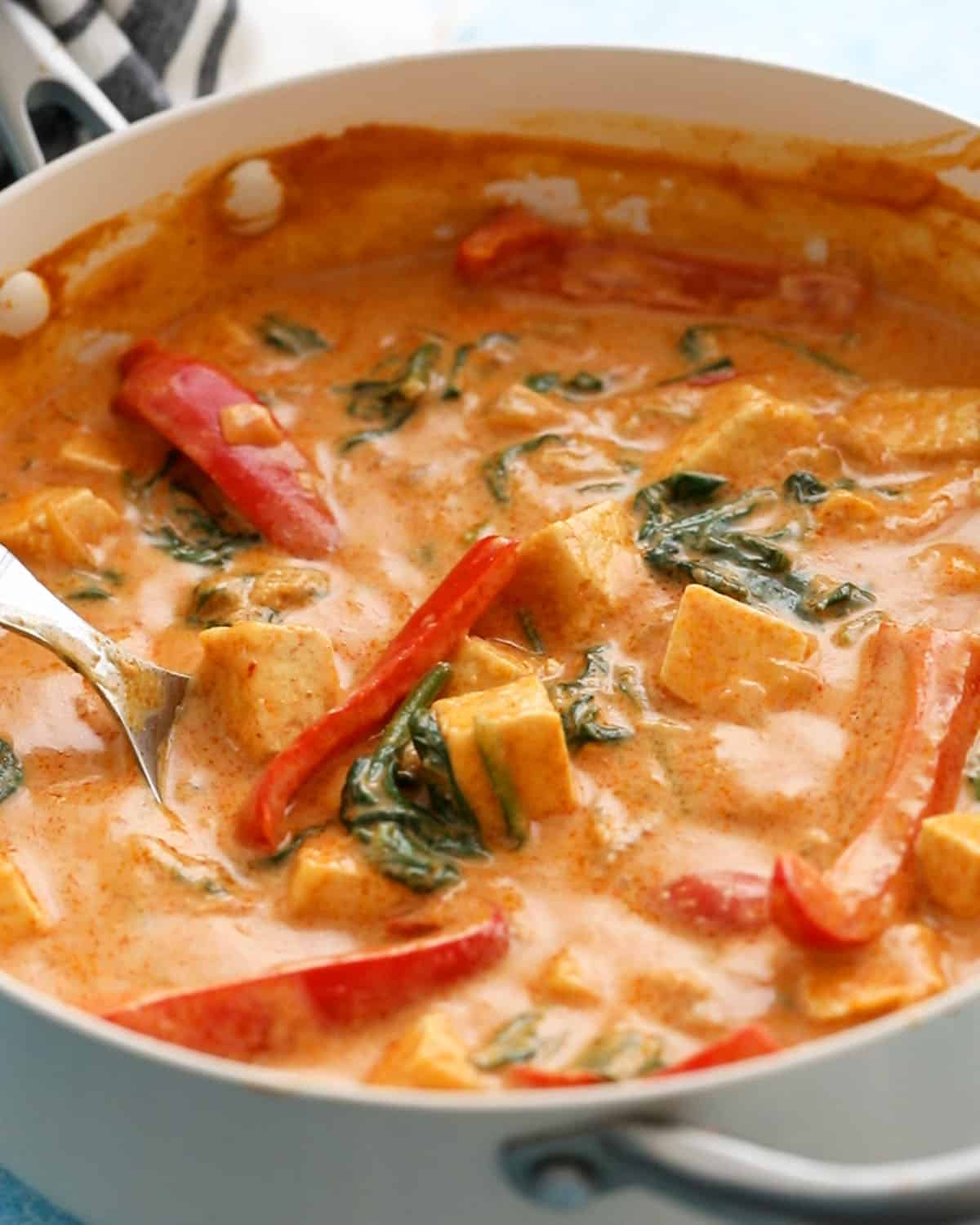 Thai red tofu curry in a white pan.