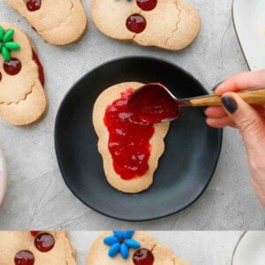 one skull cookie on a black plate.