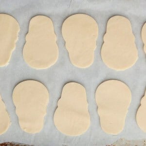 8 skull shaped cookies on a white paper.