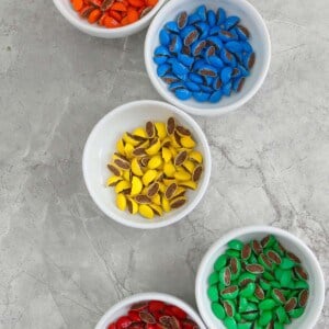 3 bowls filled with colored candy.