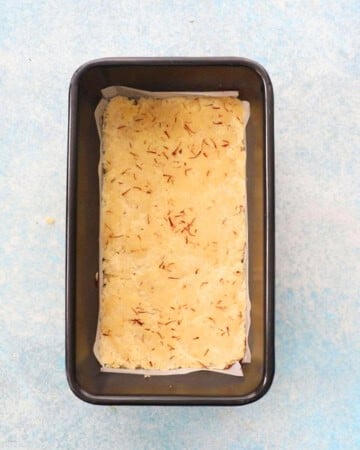 badam burfi in a metal loaf pan.