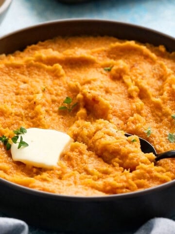 mashed butternut squash in a grey bowl.