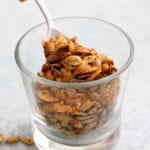 roasted butternut squash seeds in a glass cup.