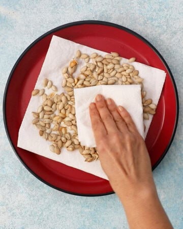 butternut squash seeds in a red plate.