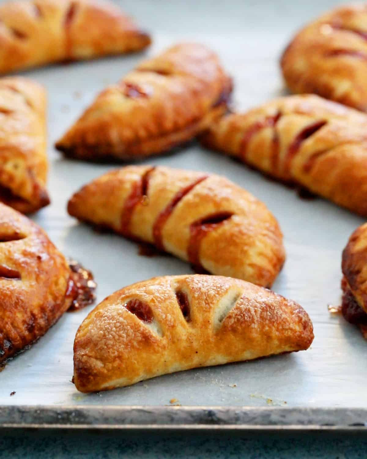 apple cranberry hand pies on a baking sheet.