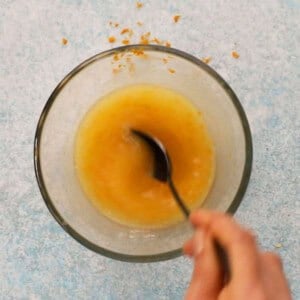 yellow orange butter in a glass bowl.