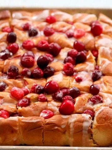 cranberry orange rolls in a baking sheet.
