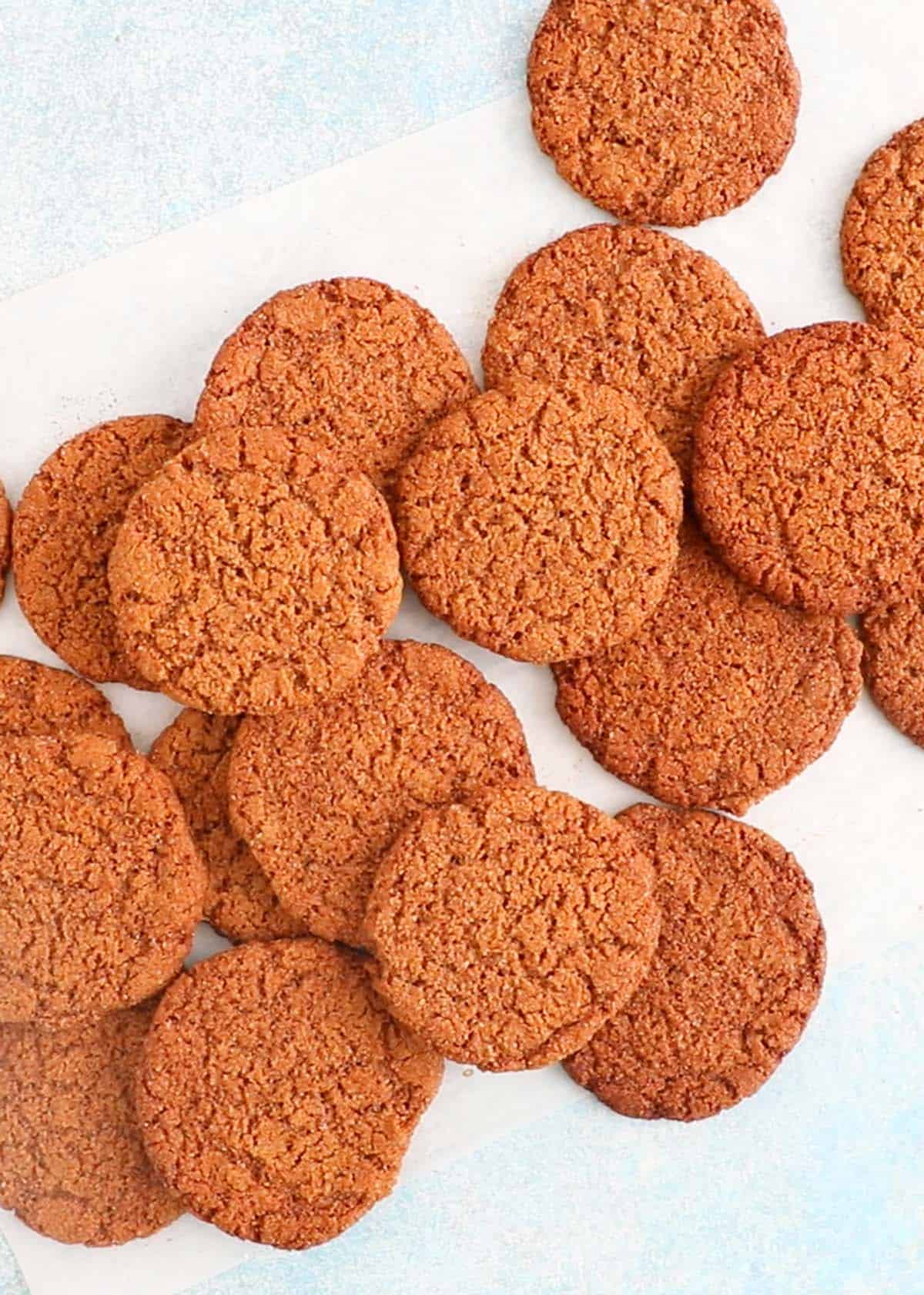 brown ginger molasses cookies on a baking sheet.