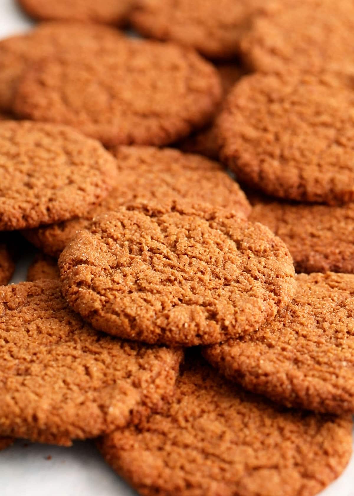 brown ginger molasses cookies on a baking sheet.