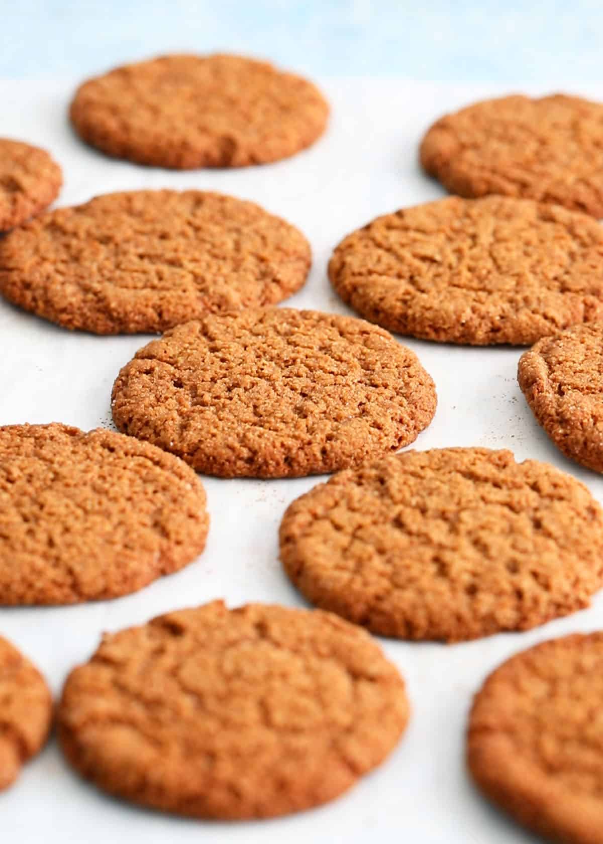 brown ginger molasses cookies on a baking sheet.