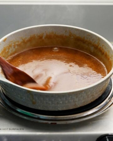brown butterscotch sauce cooking in a white pan.