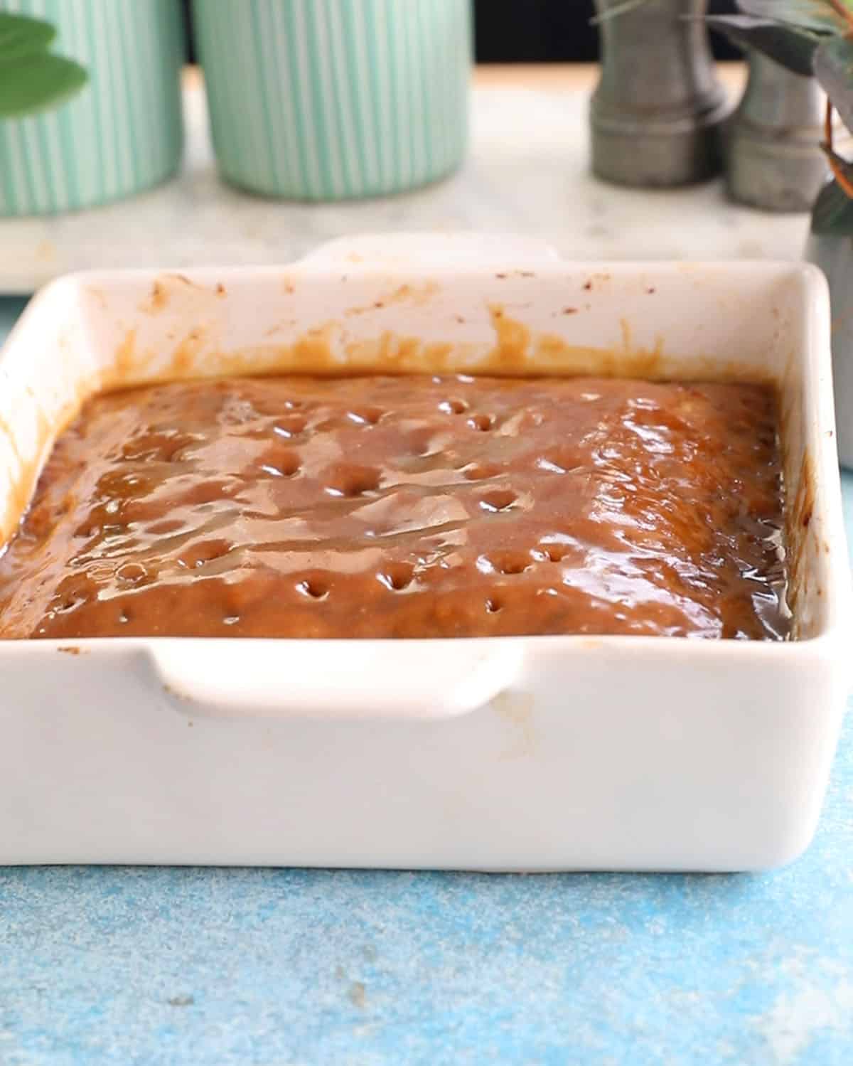 one white baking dish with brown date cake.