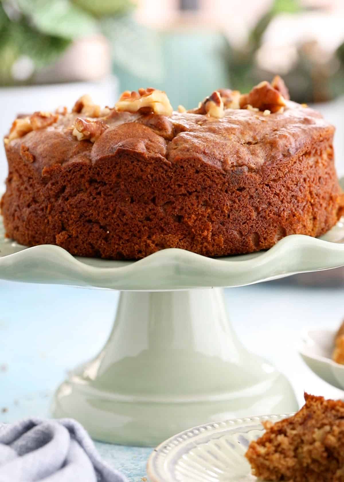 one brown date cake on a green cake stand.