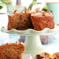 one brown date cake on a green cake stand.