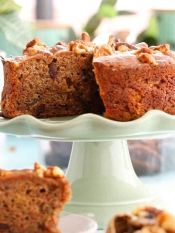one brown date cake on a green cake stand.