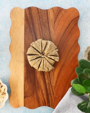 almond flour cracker dough in a brown wooden board.