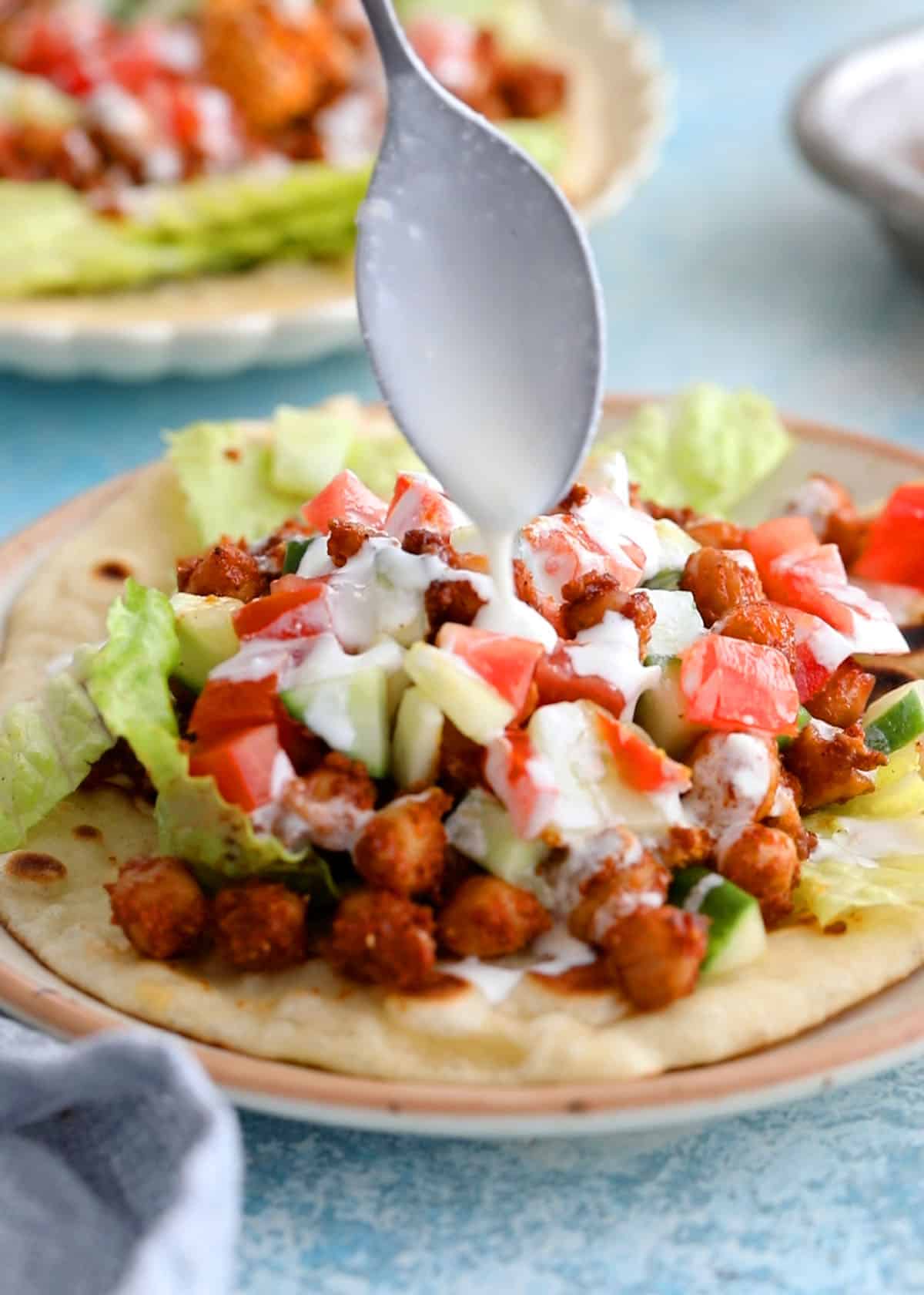 chickpeas and cauliflower wrap in a white plate.