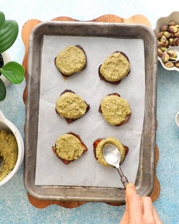6 green and brown dates in a metal sheet pan.