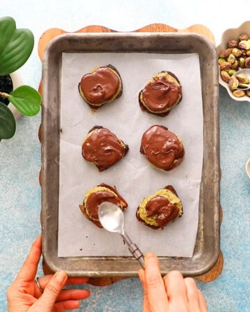 6 green and brown dates in a metal sheet pan.
