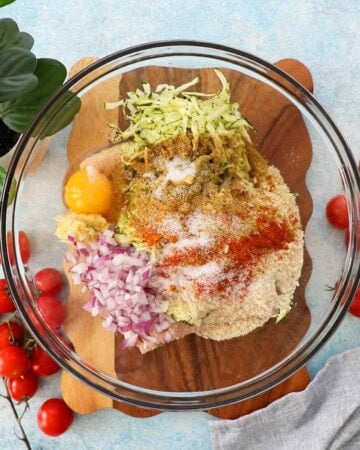 ground chicken zucchini burger mixture in a glass bowl.