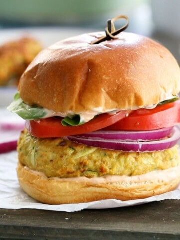 one chicken zucchini burger placed on a white paper.