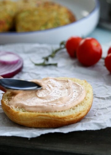 pink burger sauce on top of a half bun.