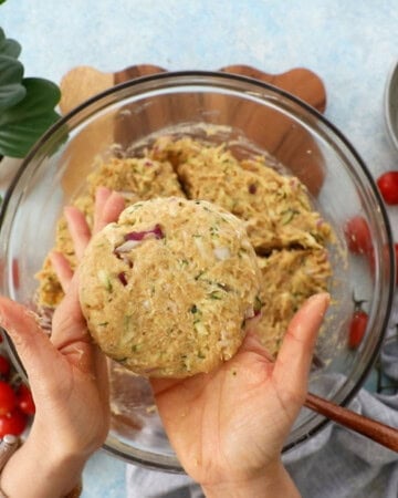 ground chicken zucchini burger mixture in a glass bowl.