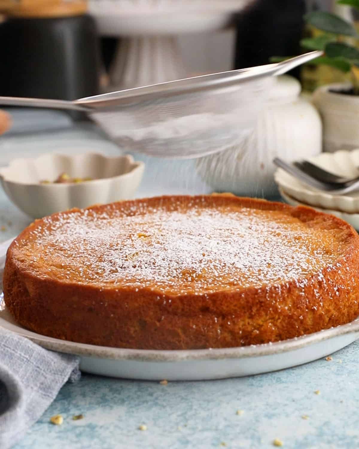 one yellow mango cake in a white platter.