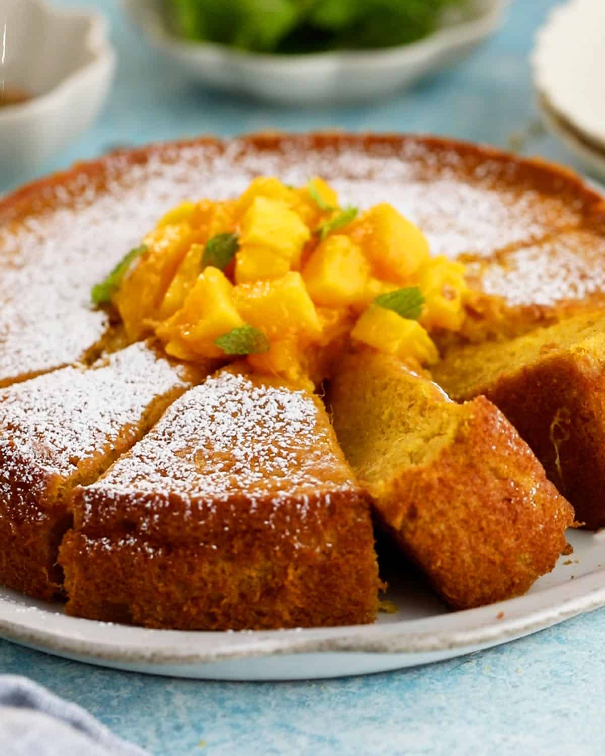 one yellow mango cake in a white platter.