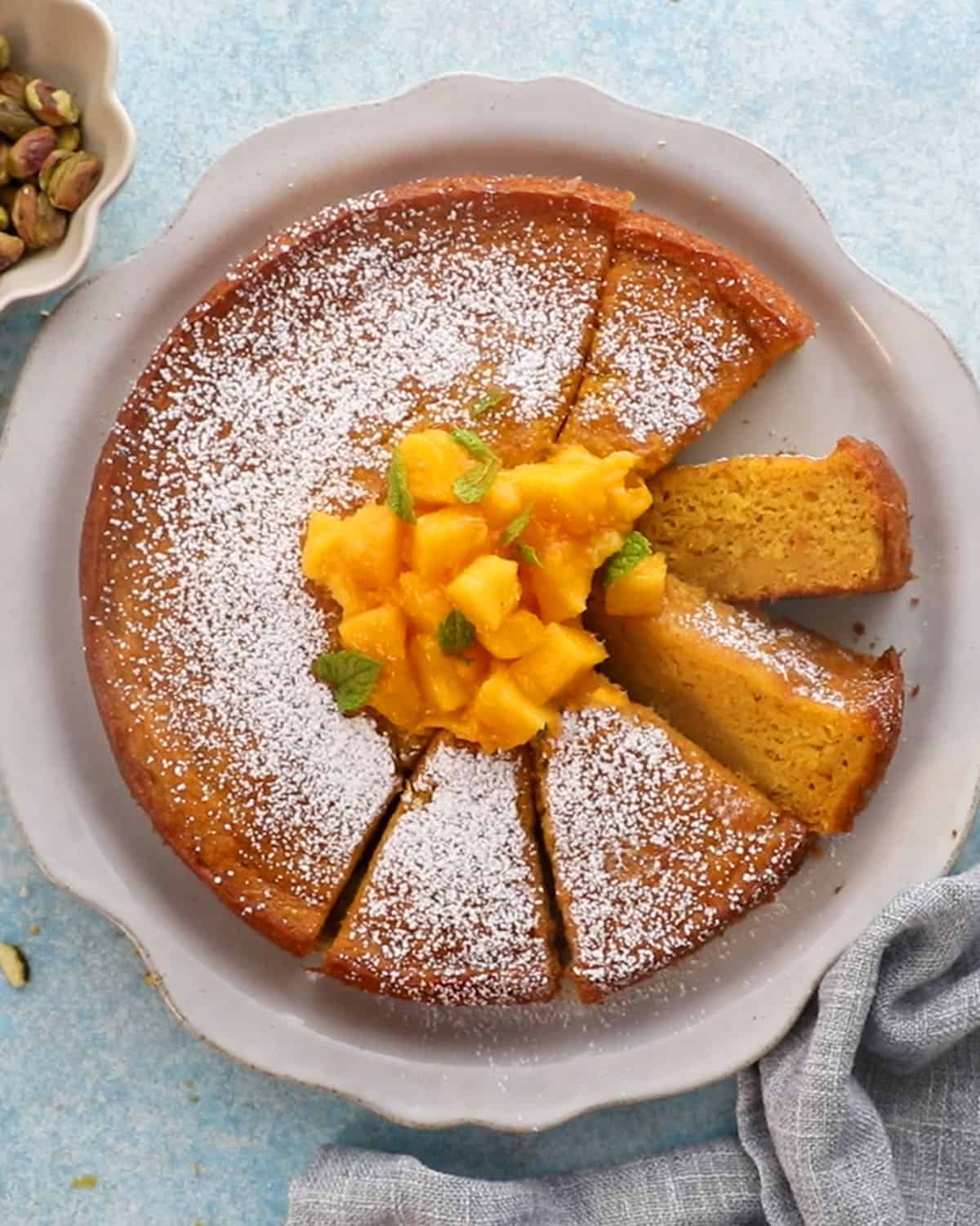 one yellow mango cake in a white platter.